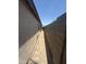 Narrow side yard with block wall and brick pathway at 3844 N 88Th Ln, Phoenix, AZ 85037