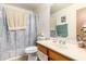 This bathroom features a vanity, mirror, toilet, towels, and a shower with a floral curtain at 403 N Monte Vista St, Chandler, AZ 85225