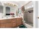 Bathroom featuring a dual sink vanity, tiled shower, and ample lighting at 403 N Monte Vista St, Chandler, AZ 85225