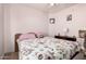 Cozy bedroom with soft lighting, floral bedding, and ceiling fan at 403 N Monte Vista St, Chandler, AZ 85225