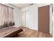 This bedroom features wood flooring, neutral walls, closet, and a window with natural light at 403 N Monte Vista St, Chandler, AZ 85225