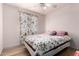 Comfortable bedroom with a floral comforter and a ceiling fan at 403 N Monte Vista St, Chandler, AZ 85225