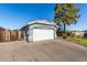 View of the home's two-car garage and spacious driveway with plenty of parking space at 403 N Monte Vista St, Chandler, AZ 85225