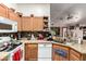 Charming kitchen with granite countertops, stainless steel appliances, and wood cabinetry at 403 N Monte Vista St, Chandler, AZ 85225