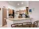 Well-lit kitchen featuring a breakfast bar, wooden cabinets, and plenty of counter space at 403 N Monte Vista St, Chandler, AZ 85225