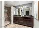 Bathroom with dual vanity, framed mirrors, vanity lighting, and a shower stall at 4135 E Altadena Ave, Phoenix, AZ 85028
