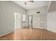 Bedroom with hardwood floors, ceiling fan, closet, and doors to an ensuite bath at 4135 E Altadena Ave, Phoenix, AZ 85028