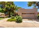 Charming home with a two-car garage, mature trees, and lush landscaping enhancing curb appeal at 4135 E Altadena Ave, Phoenix, AZ 85028