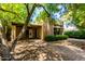Landscaped front exterior featuring trees, brick driveway, and modern elevation at 4135 E Altadena Ave, Phoenix, AZ 85028