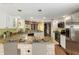 Bright kitchen featuring granite countertops, modern appliances, white cabinets, and laminate flooring at 4135 E Altadena Ave, Phoenix, AZ 85028