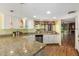 Spacious kitchen with granite counters, white cabinets, stainless appliances, and wood look flooring at 4135 E Altadena Ave, Phoenix, AZ 85028