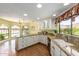 Bright kitchen featuring granite countertops, white cabinets, stainless appliances, and modern lighting at 4135 E Altadena Ave, Phoenix, AZ 85028