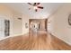 Bright living room featuring laminate wood flooring, arched doorways, and recessed lighting at 4135 E Altadena Ave, Phoenix, AZ 85028