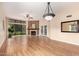 Spacious living room with fireplace, ceiling fan, laminate wood flooring, and natural light at 4135 E Altadena Ave, Phoenix, AZ 85028