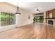 Spacious living room featuring fireplace, ceiling fan, and laminate wood flooring at 4135 E Altadena Ave, Phoenix, AZ 85028