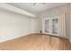 Bright living room featuring hardwood floors and double doors to a patio at 4135 E Altadena Ave, Phoenix, AZ 85028