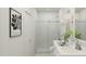 Stylish bathroom with glass-enclosed shower, double sinks, and modern lighting at 42515 W Peters Dr, Maricopa, AZ 85138
