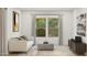 Relaxing living room with neutral tones, large windows, a comfortable sofa, and modern decor at 42515 W Peters Dr, Maricopa, AZ 85138