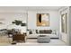 Cozy living room featuring neutral decor, a comfortable sofa, and contemporary artwork at 42515 W Peters Dr, Maricopa, AZ 85138
