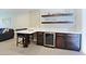 Stylish kitchen bar features dark cabinets, seating and prep space at 4600 N 68Th St # 351, Scottsdale, AZ 85251
