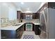 Modern kitchen featuring stainless steel appliances and dark cabinetry at 4600 N 68Th St # 351, Scottsdale, AZ 85251