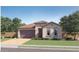 Charming single-story home featuring a tile roof, arched windows, manicured lawn, and a two-car garage at 4924 S 232Nd Ln, Buckeye, AZ 85326