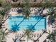 Aerial view of a large pool surrounded by palm trees and lounge chairs, creating a private oasis at 5050 N Camelback Ridge Dr # 2306, Scottsdale, AZ 85251