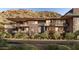 Modern building showcasing balconies and desert landscaping against a mountain backdrop at 5050 N Camelback Ridge Dr # 2306, Scottsdale, AZ 85251
