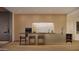 Modern kitchen with sleek wood cabinetry and counter seating at 5050 N Camelback Ridge Dr # 2306, Scottsdale, AZ 85251