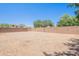 Expansive backyard space with gravel cover and a block wall for privacy at 5434 W T Ryan Ln, Laveen, AZ 85339