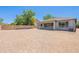 Backyard space with gravel and a view of the house exterior with windows at 5434 W T Ryan Ln, Laveen, AZ 85339