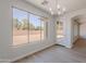 Dining room with large windows and modern chandelier at 5434 W T Ryan Ln, Laveen, AZ 85339