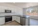 Kitchen with stainless steel appliances, white cabinetry, and granite counters at 5434 W T Ryan Ln, Laveen, AZ 85339
