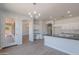 Bright kitchen with stainless steel sink, white cabinets and granite counters at 5434 W T Ryan Ln, Laveen, AZ 85339