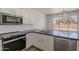 Bright kitchen with stainless steel appliances, granite countertops, and subway tile backsplash at 5434 W T Ryan Ln, Laveen, AZ 85339