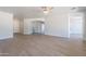 Large living room with luxury floors, ceiling fan, and bright natural light at 5434 W T Ryan Ln, Laveen, AZ 85339