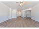 Open living room with wood look floors and ample natural light at 5434 W T Ryan Ln, Laveen, AZ 85339