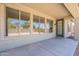 Covered patio area featuring large windows and a doorway to backyard at 5434 W T Ryan Ln, Laveen, AZ 85339