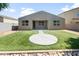 Picture of the home's backyard, featuring a manicured lawn, patio, and low-maintenance desert landscaping at 626 W Tallula Trl, San Tan Valley, AZ 85140