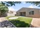 Backyard featuring desert landscaping, artificial turf, and a patio area, offering a low-maintenance outdoor space at 626 W Tallula Trl, San Tan Valley, AZ 85140