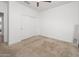 A cozy bedroom with a ceiling fan and sliding closet doors at 626 W Tallula Trl, San Tan Valley, AZ 85140