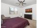Comfortable bedroom with carpet, natural light, and ceiling fan provides a calming space at 626 W Tallula Trl, San Tan Valley, AZ 85140