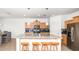 Well-equipped kitchen featuring barstool seating, a kitchen island with a sink, and modern stainless steel appliances at 626 W Tallula Trl, San Tan Valley, AZ 85140