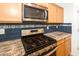 Well-equipped kitchen with stainless steel appliances and granite countertops, perfect for culinary enthusiasts at 626 W Tallula Trl, San Tan Valley, AZ 85140