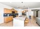 Beautiful kitchen featuring granite countertops, barstool seating, stainless steel appliances, and tile flooring at 626 W Tallula Trl, San Tan Valley, AZ 85140