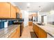 Modern kitchen boasting granite countertops, stainless steel appliances, tile backsplash, and barstool seating at 626 W Tallula Trl, San Tan Valley, AZ 85140