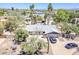 An aerial view of the home featuring lush desert landscaping, pool, and two parked cars at 6302 E Turquoise Ave, Paradise Valley, AZ 85253