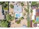 Aerial view of a home with desert landscaping, pool, multiple buildings, and green grass at 6302 E Turquoise Ave, Paradise Valley, AZ 85253