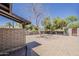Wide shot of the spacious backyard featuring a brick wall, desert landscaping, and a paved patio at 6302 E Turquoise Ave, Paradise Valley, AZ 85253