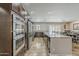 Spacious gourmet kitchen with granite countertops, stainless steel appliances, and seamless flow into the dining area at 6302 E Turquoise Ave, Paradise Valley, AZ 85253